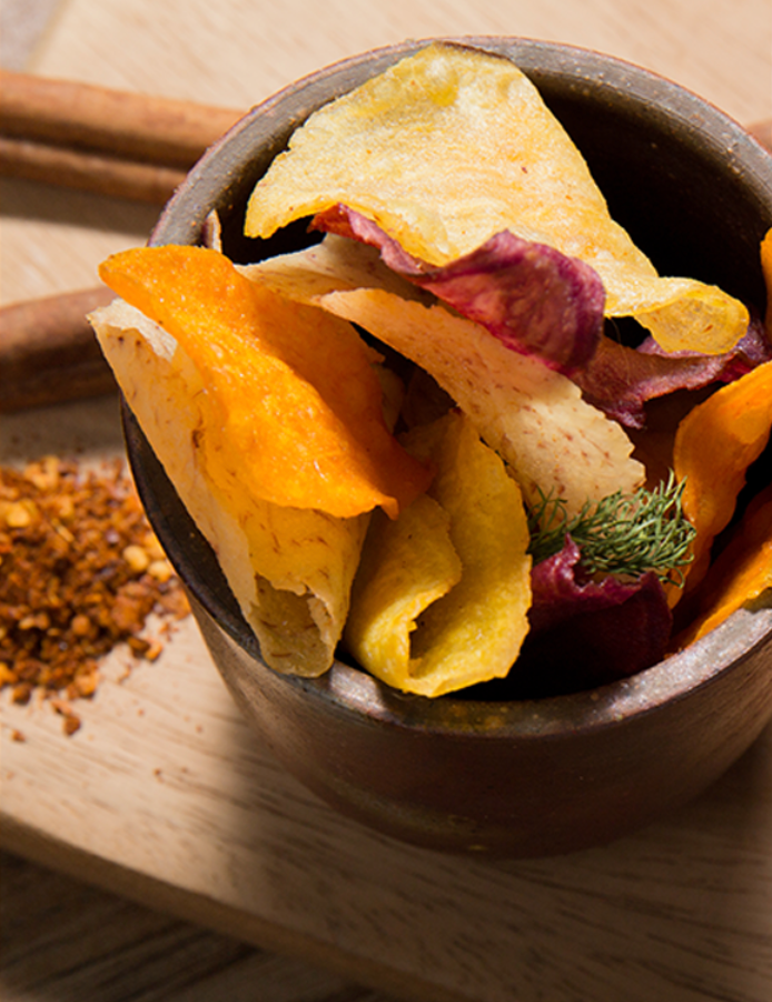 Mixed colorful root vegetable chips served in a bowl
